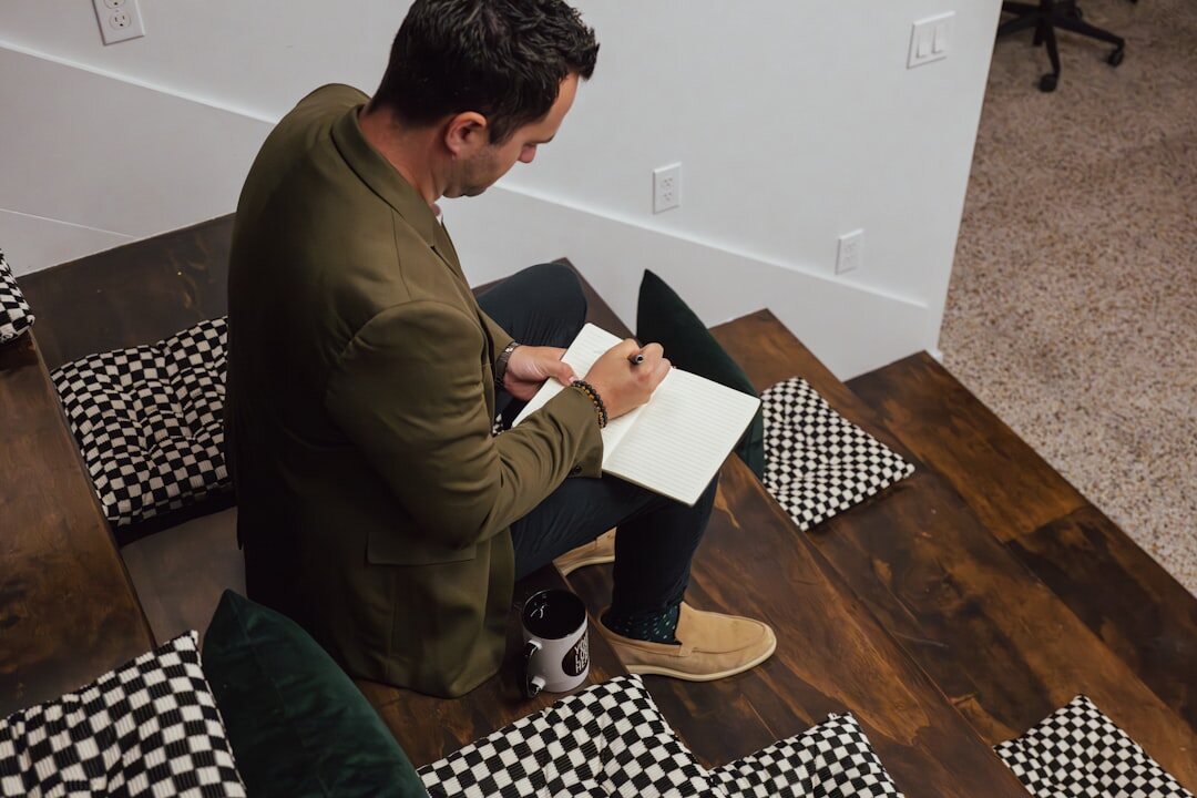 man writing in journal